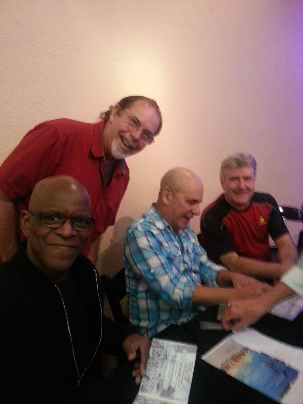 Bruce and three fellow musicians at a table after a gig