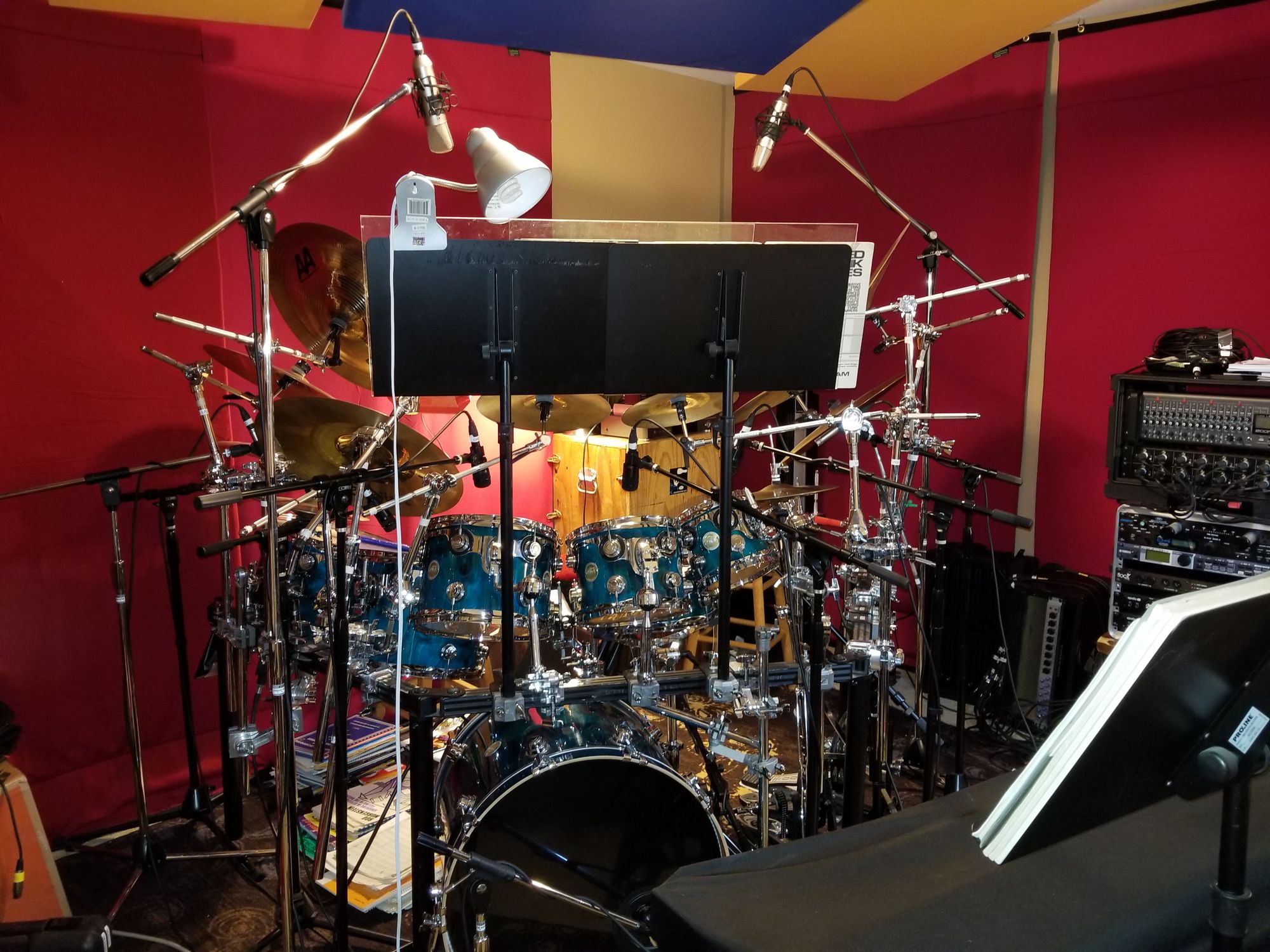 The blue DW maple kit in the red drum room