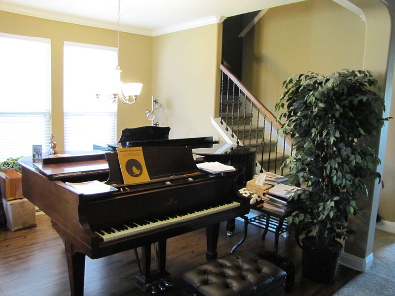 A second grand piano beside the staircase