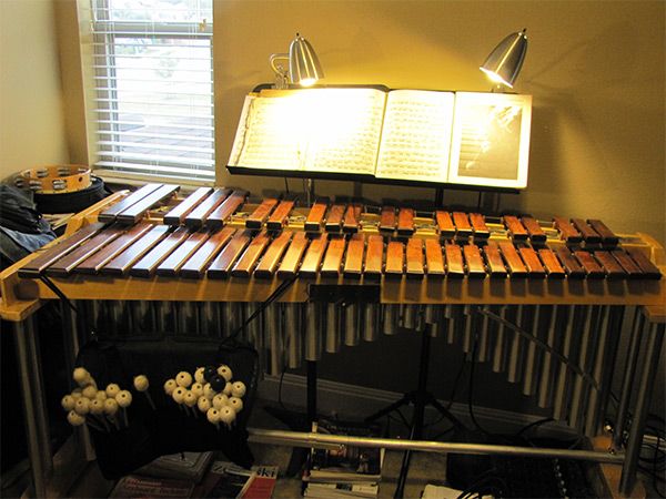 The Jenco rosewood marimba with a rack of mallets underneath